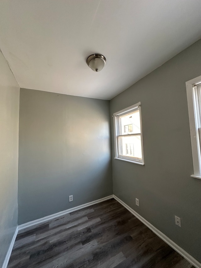 empty room with dark wood-type flooring