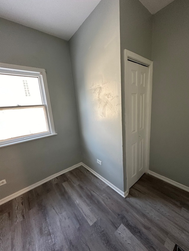 empty room with dark hardwood / wood-style flooring