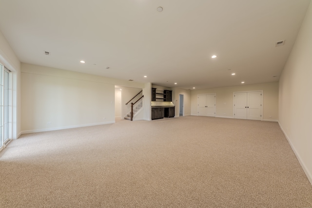 unfurnished living room with light carpet