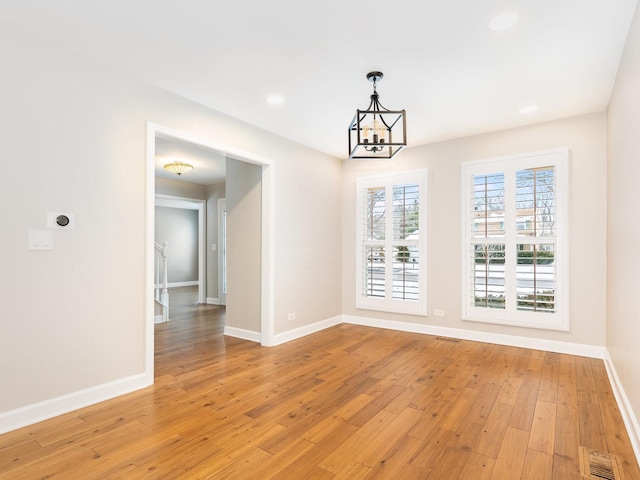 interior space with light hardwood / wood-style flooring and a notable chandelier