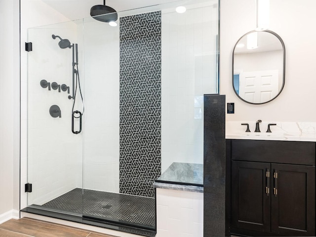 bathroom with vanity, a shower with door, and wood-type flooring