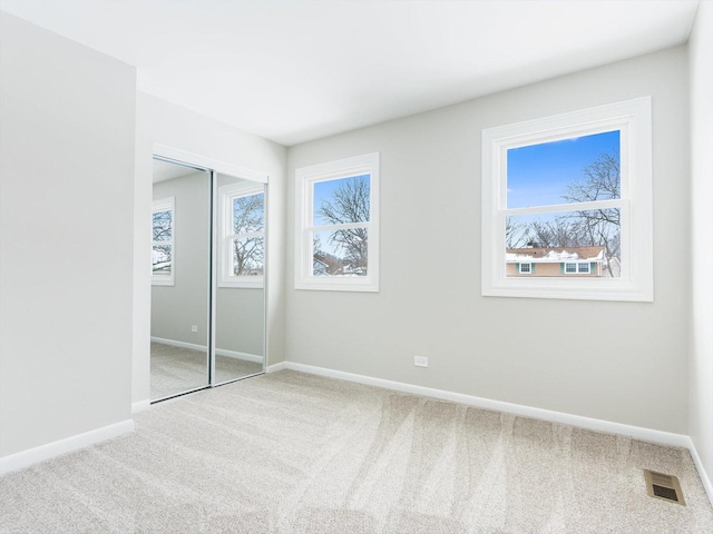 unfurnished bedroom featuring a closet and carpet floors