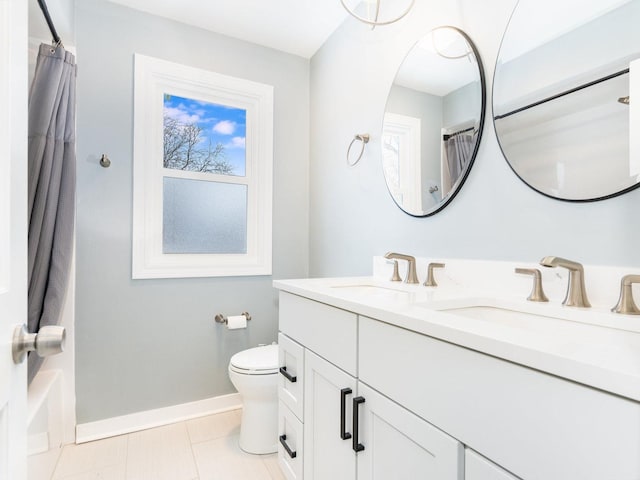 bathroom with curtained shower, toilet, tile patterned floors, and vanity