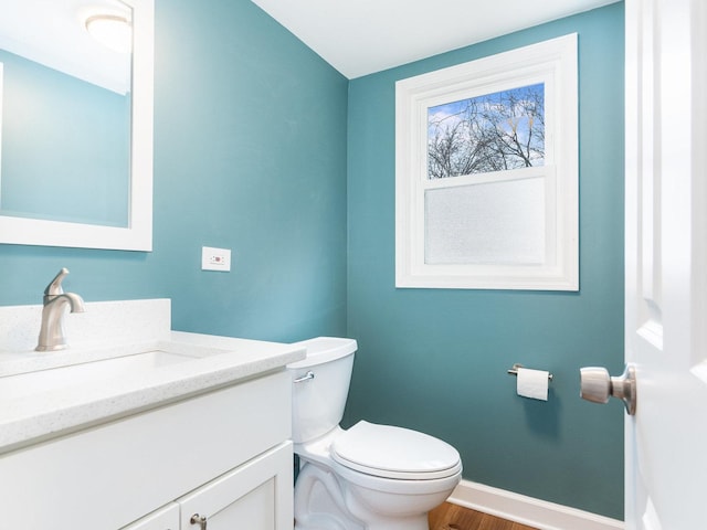 bathroom with vanity, toilet, and wood-type flooring