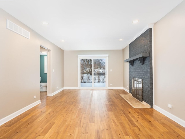 unfurnished living room with light hardwood / wood-style floors and a fireplace