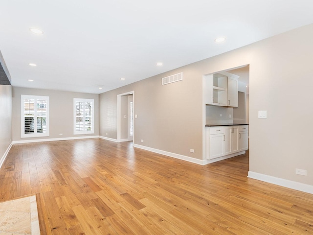 unfurnished living room with light hardwood / wood-style flooring