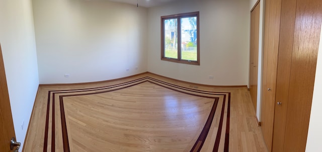 unfurnished room with light hardwood / wood-style floors