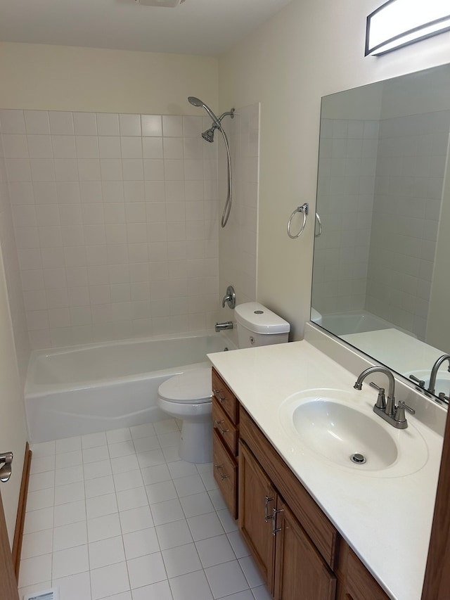 full bathroom with toilet, tiled shower / bath combo, vanity, and tile patterned floors