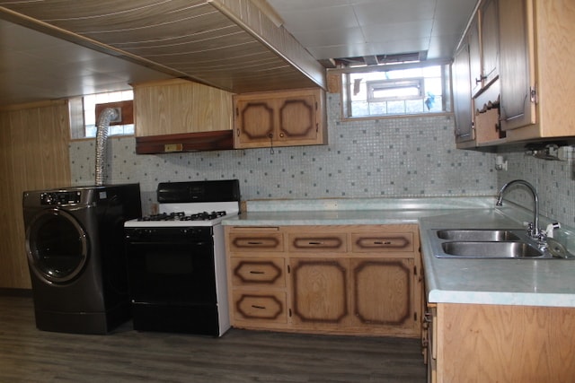 kitchen with backsplash, washer / clothes dryer, sink, dark wood-type flooring, and white gas stove