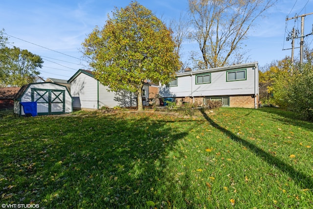 rear view of property with a lawn and a shed