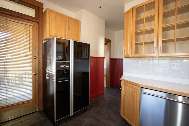 kitchen featuring decorative backsplash, black fridge with ice dispenser, stainless steel dishwasher, and dark tile patterned flooring