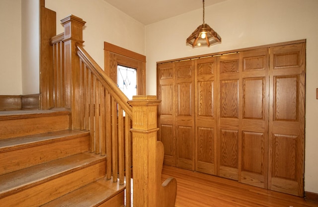 staircase with hardwood / wood-style flooring