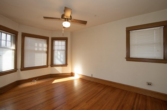 spare room with hardwood / wood-style flooring and ceiling fan