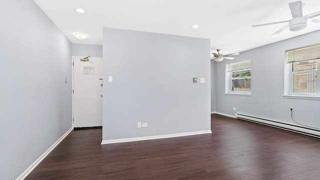 empty room with ceiling fan, a baseboard radiator, and dark hardwood / wood-style floors