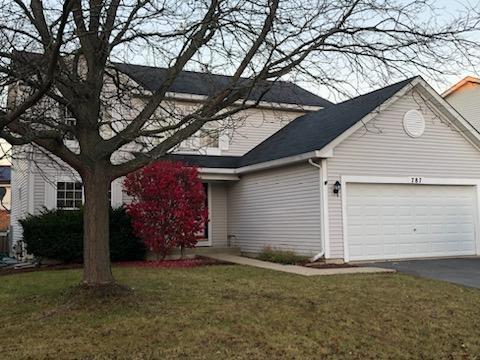 view of front of house with a garage and a front lawn