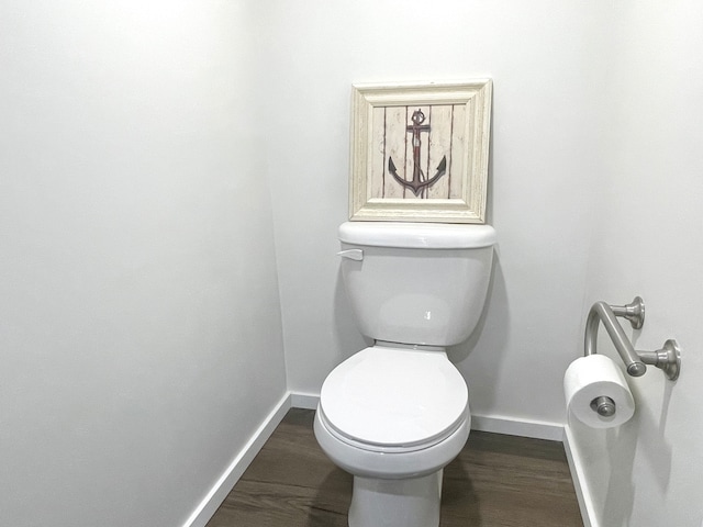 bathroom with wood-type flooring and toilet