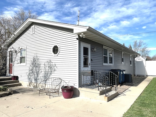 rear view of house featuring central AC and a patio area