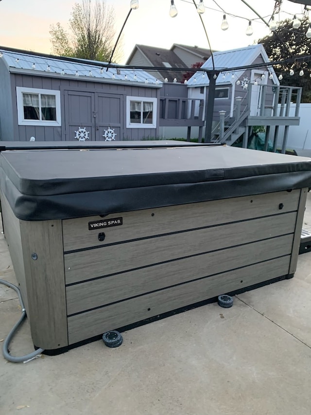 exterior details featuring a jacuzzi and concrete flooring