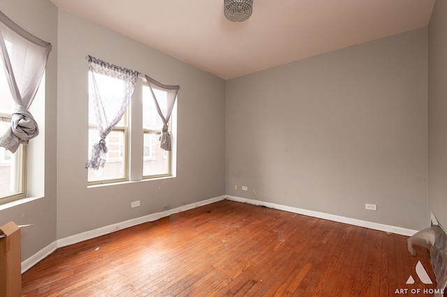 unfurnished room with hardwood / wood-style floors