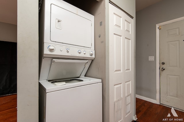 washroom with stacked washer / dryer and dark hardwood / wood-style flooring