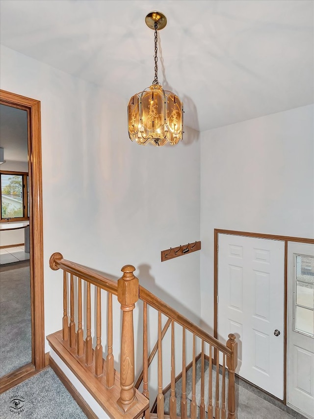 interior space featuring a chandelier and carpet flooring