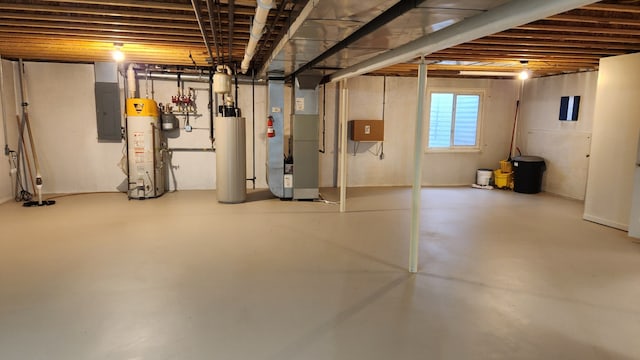 basement featuring gas water heater, electric panel, and heating unit