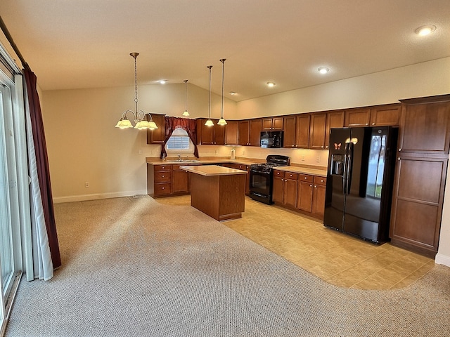 kitchen featuring black appliances, vaulted ceiling, decorative light fixtures, a kitchen island, and a chandelier