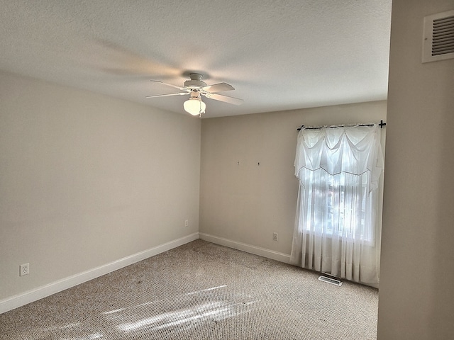 empty room with carpet, a textured ceiling, and ceiling fan