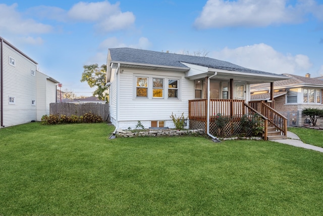 view of front of property featuring a front lawn and a deck