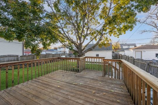 wooden deck with a lawn