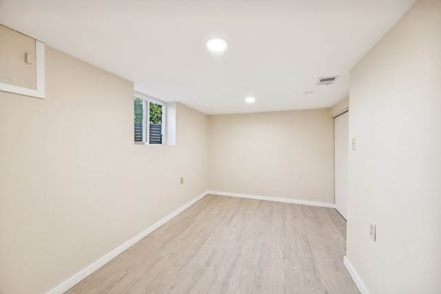 basement with light hardwood / wood-style floors