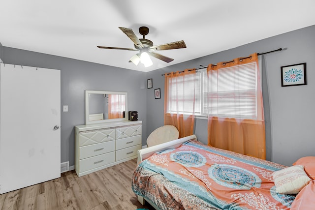 bedroom with light hardwood / wood-style floors and ceiling fan