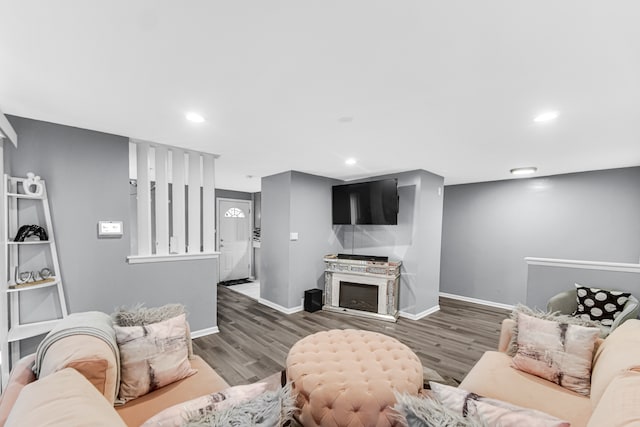 living room with a fireplace and dark wood-type flooring