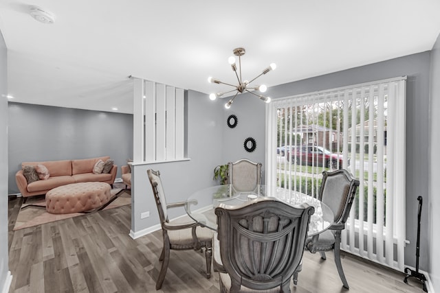 dining room with a chandelier and light hardwood / wood-style floors