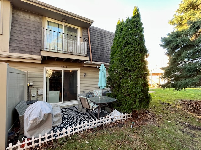 back of property with a balcony