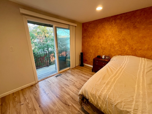 unfurnished bedroom with access to exterior and light hardwood / wood-style floors