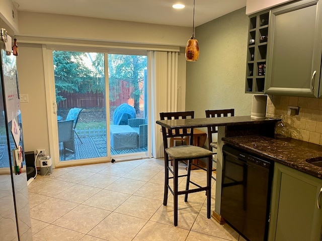 kitchen featuring dark stone counters, backsplash, decorative light fixtures, green cabinets, and dishwasher