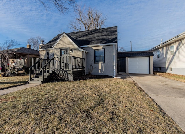 view of front of house with a garage, a front yard, and a deck