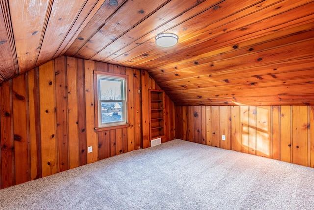 bonus room featuring wooden walls, wooden ceiling, and carpet flooring