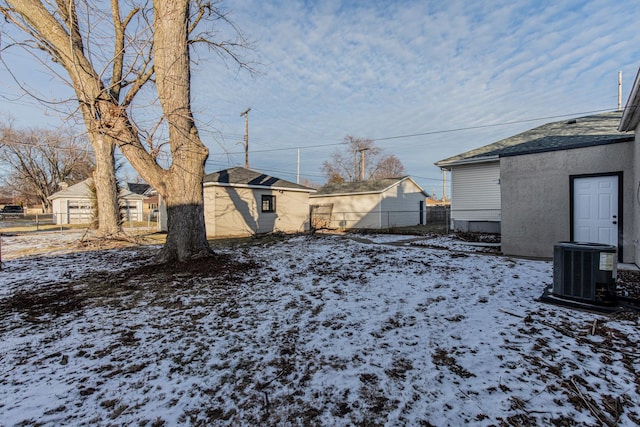 yard layered in snow featuring central AC unit