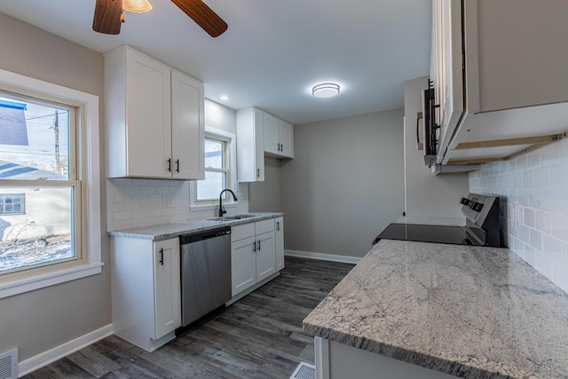 kitchen featuring sink, white cabinetry, stainless steel appliances, light stone countertops, and backsplash