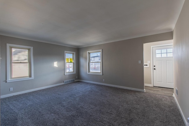 empty room with dark colored carpet