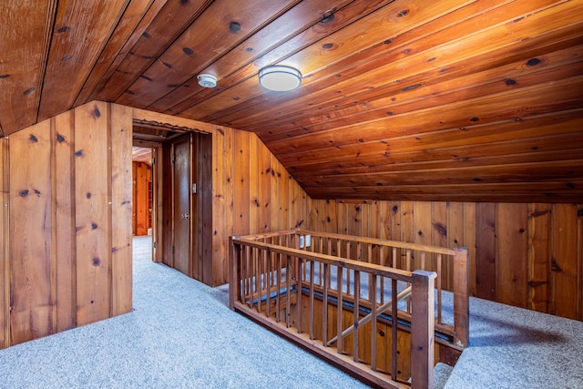 additional living space with light carpet, wood ceiling, wooden walls, and vaulted ceiling