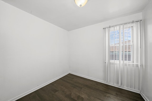 empty room with dark wood-type flooring