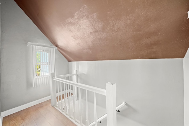 interior space featuring lofted ceiling and hardwood / wood-style floors