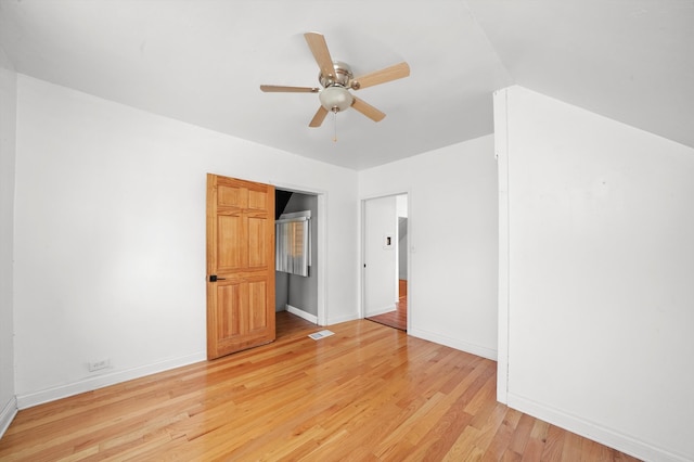 interior space with light wood-type flooring, lofted ceiling, and ceiling fan