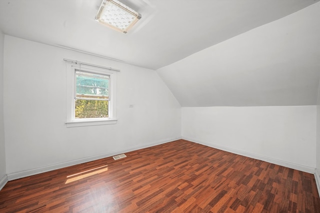 bonus room with vaulted ceiling and dark hardwood / wood-style flooring