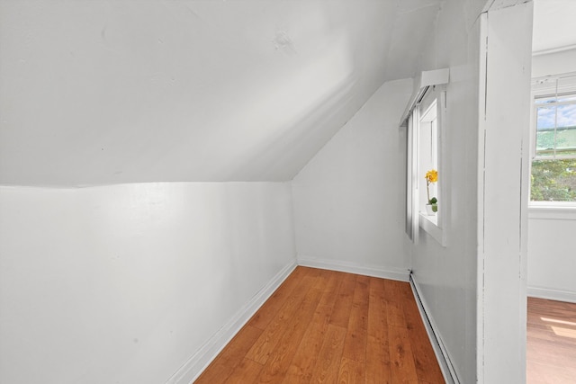 bonus room with light hardwood / wood-style floors and vaulted ceiling