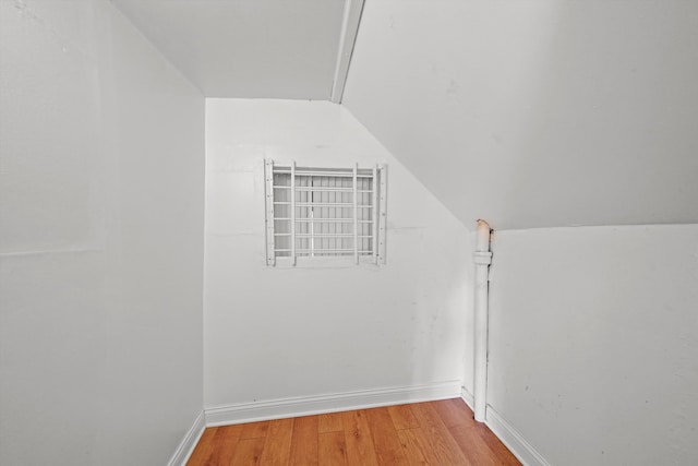 interior space featuring hardwood / wood-style flooring and vaulted ceiling