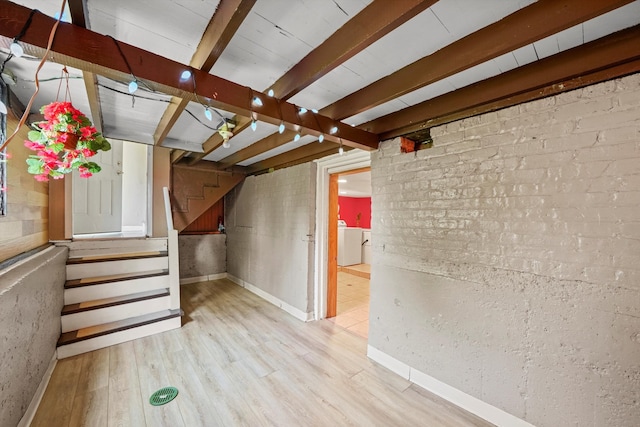 basement with light wood-type flooring and washer / clothes dryer